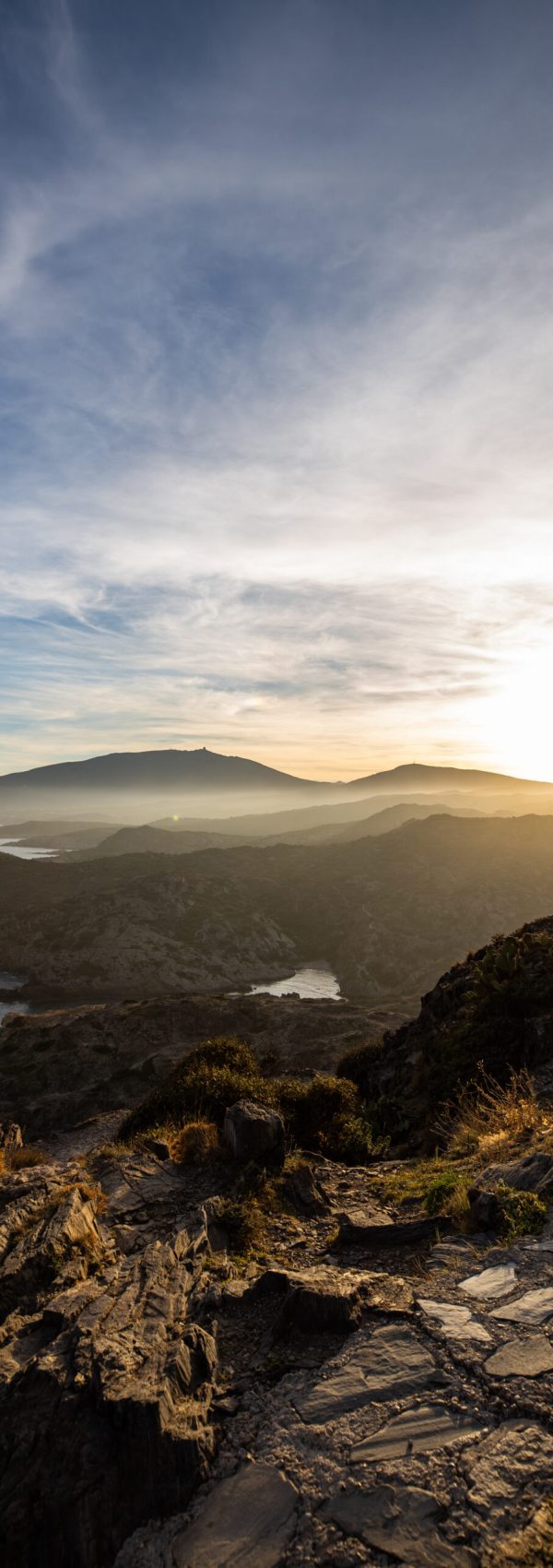 Sunset over sea cliffs and low clouds with clear sky view from Cap de Creus, Catalonia (SPAIN)